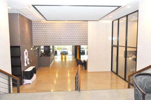 Modern lobby interior with glossy tile flooring and front desk