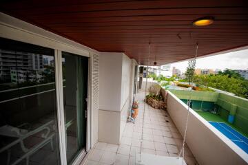 Spacious balcony with wooden ceiling and city view