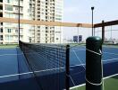 Tennis court on rooftop with cityscape background