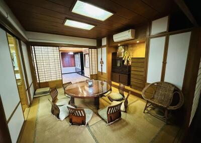 Spacious traditional Japanese living room with tatami floors and shoji screens
