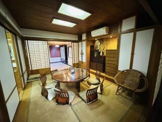 Spacious traditional Japanese living room with tatami floors and shoji screens