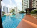 Spacious communal swimming pool with city skyline view