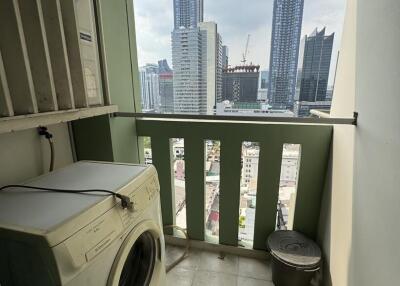 Compact balcony with laundry machine and city view