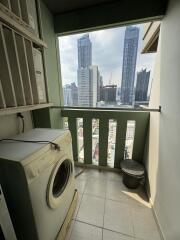 Compact balcony with laundry machine and city view