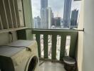 Compact balcony with laundry machine and city view