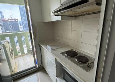 Compact kitchen space with modern appliances and city view