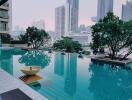 Luxurious outdoor swimming pool with cityscape background