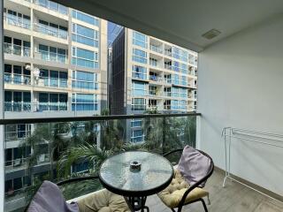 Cozy balcony with a view of surrounding buildings and comfortable seating