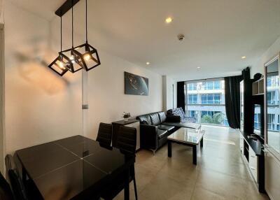 Modern living room with open floor plan, elegant lighting, and contemporary furniture