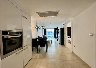 Modern Open Plan Kitchen with Dining Area Leading to Balcony