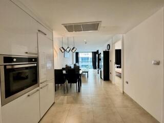 Modern Open Plan Kitchen with Dining Area Leading to Balcony