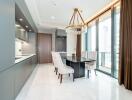 Modern kitchen with dining area, full-length windows, and chandelier