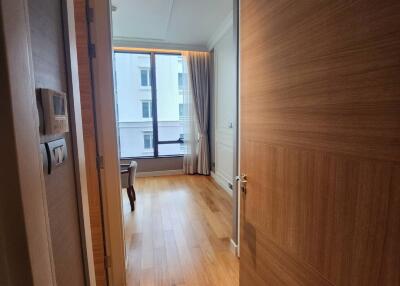 Bright apartment corridor leading to a living room with natural light