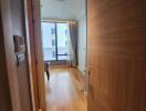 Bright apartment corridor leading to a living room with natural light