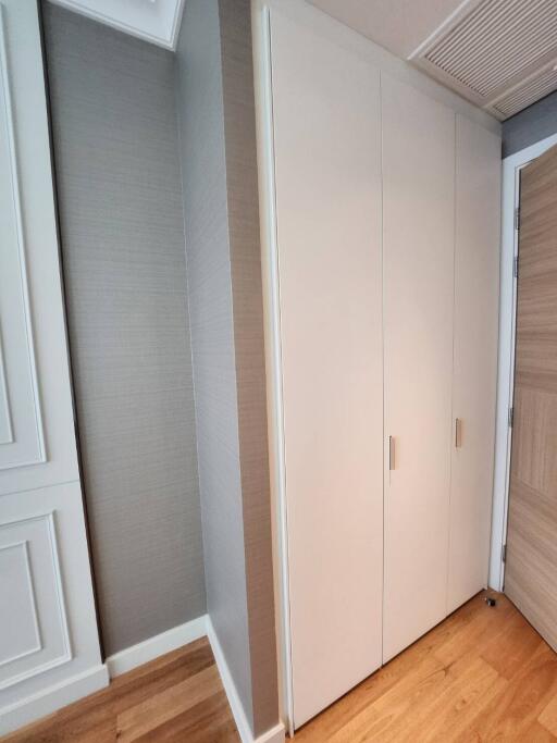 Compact Bedroom with Built-in Closet and Hardwood Flooring