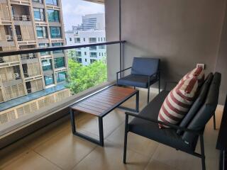 Cozy balcony with seating arrangement and a view of other buildings
