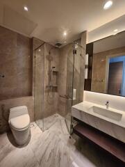 Modern bathroom with marble finish and glass shower