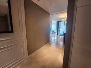 Elegant hallway leading to a brightly lit living space