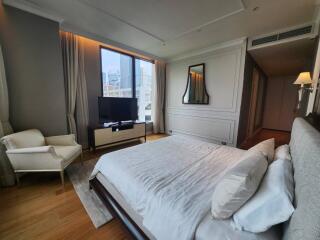 Spacious bedroom with large bed and city view