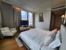 Spacious bedroom with large bed and city view