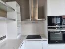 Modern kitchen with stainless steel appliances and white cabinetry