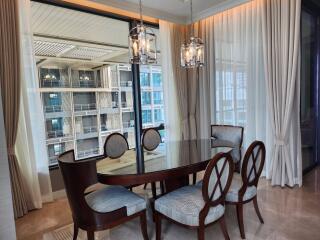 Elegant dining room with natural light and modern chandeliers