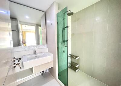 Modern bathroom with glass shower and floating vanity