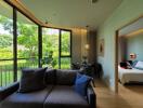 Modern living room with garden view, natural light, and contemporary furniture