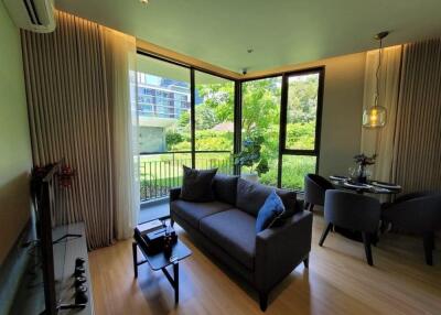 Modern living room with large windows and garden view