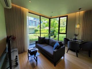 Modern living room with large windows and garden view