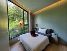 Modern bedroom with large window overlooking greenery