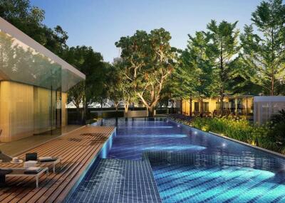 Luxurious outdoor pool area with lounge chairs and lush greenery