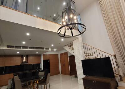 Spacious modern living room with high ceiling and mezzanine