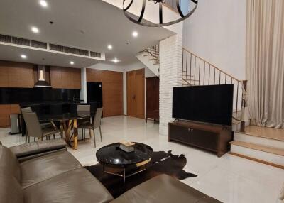 Spacious modern living room with open-plan kitchen and staircase