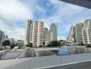 Cityscape view from balcony with high-rise buildings and solar panels