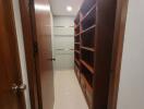 Corridor view in a modern home featuring built-in shelves and tiled flooring