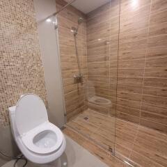 Modern bathroom with glass shower and tiled walls