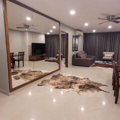 Spacious modern living room with dining area and large mirrored wall