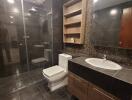 Modern bathroom with glass shower enclosure and wooden vanity