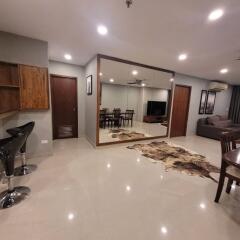 Modern spacious living room with dining area and glossy tiled flooring