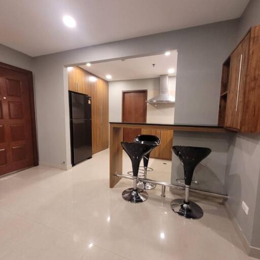 Modern kitchen with bar stools and wooden cabinets