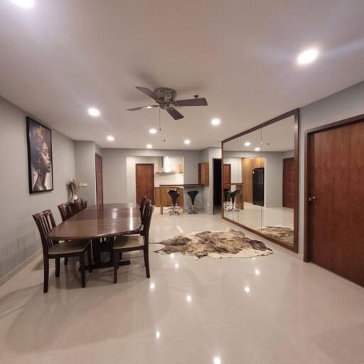 Spacious dining room with modern lighting and glossy tiled flooring