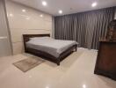 Spacious bedroom with queen-sized bed and modern decor