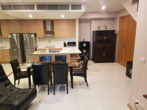 Modern kitchen with dining area and stainless steel appliances