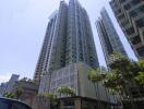 Modern high-rise apartment building exterior under a clear blue sky