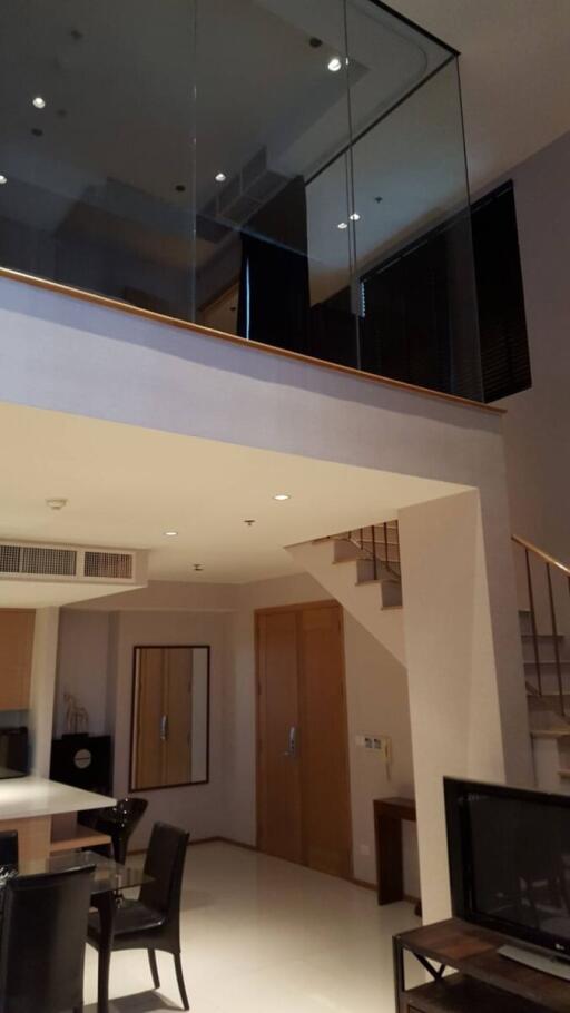 Modern living room with high ceiling and mezzanine