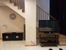 Modern living room interior with staircase and television