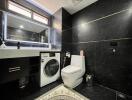 Modern bathroom with black marble walls featuring a washing machine