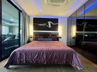 Modern bedroom with artistic decor and ambient lighting