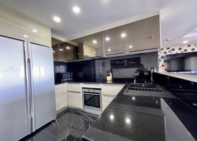 Modern kitchen with stainless steel appliances and dark countertops